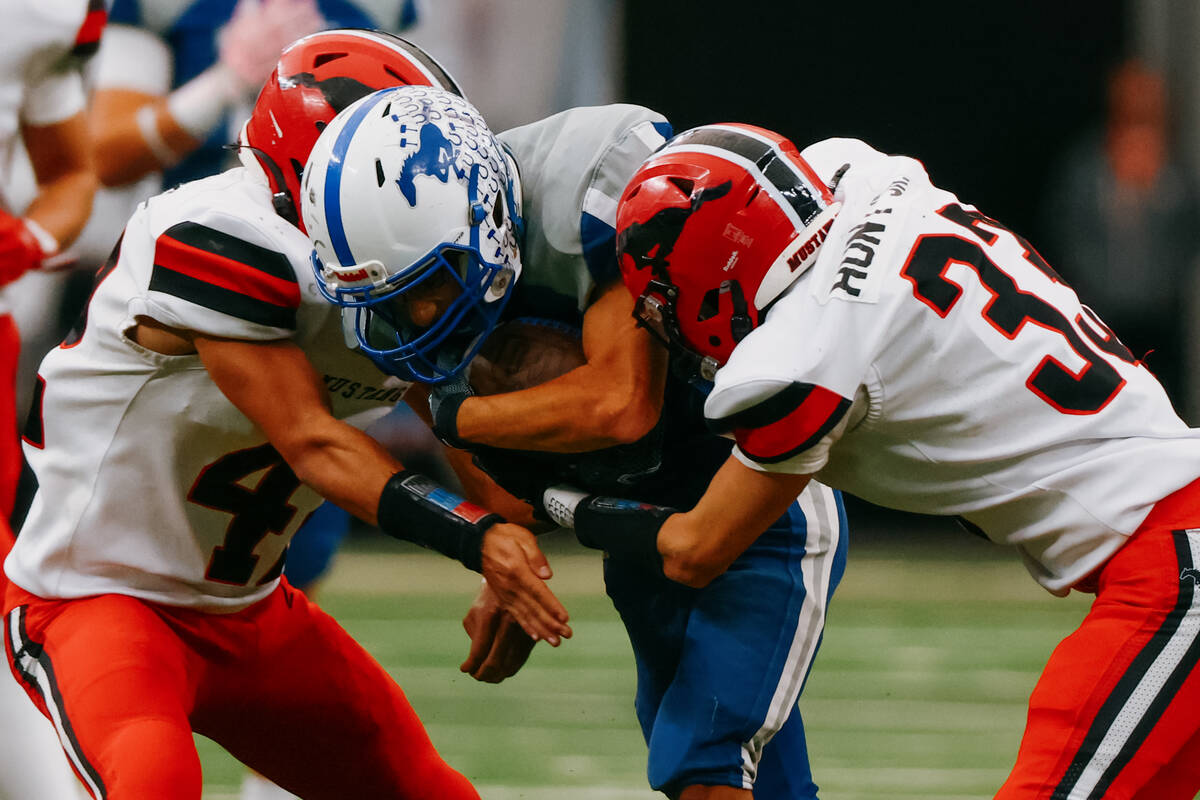 Pershing County defensive end Ashton Jimenez (42) and strong safety Josiah Hunt (33) tackle Nee ...