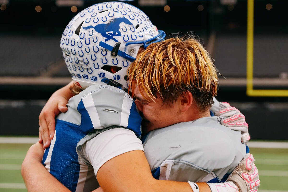 Needles’ Brayden Baca (10) and Anthony Gomez (65) embrace after winning the 2A state cha ...