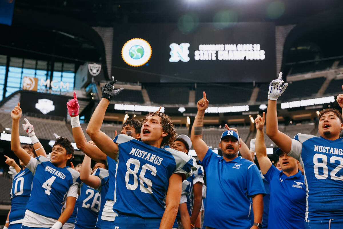 Needles players sing their school song to the crowd after winning the 2A state championship gam ...