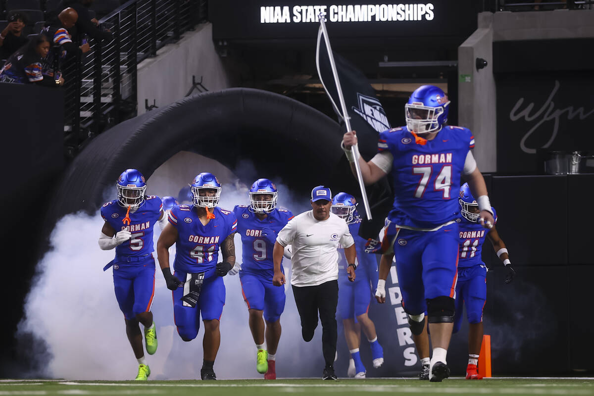 Bishop Gorman players run onto the field before taking on Arbor View in the Open Division NIAA ...