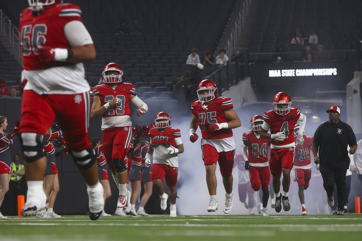 Arbor View players run onto the field before taking on Bishop Gorman in the Open Division NIAA ...