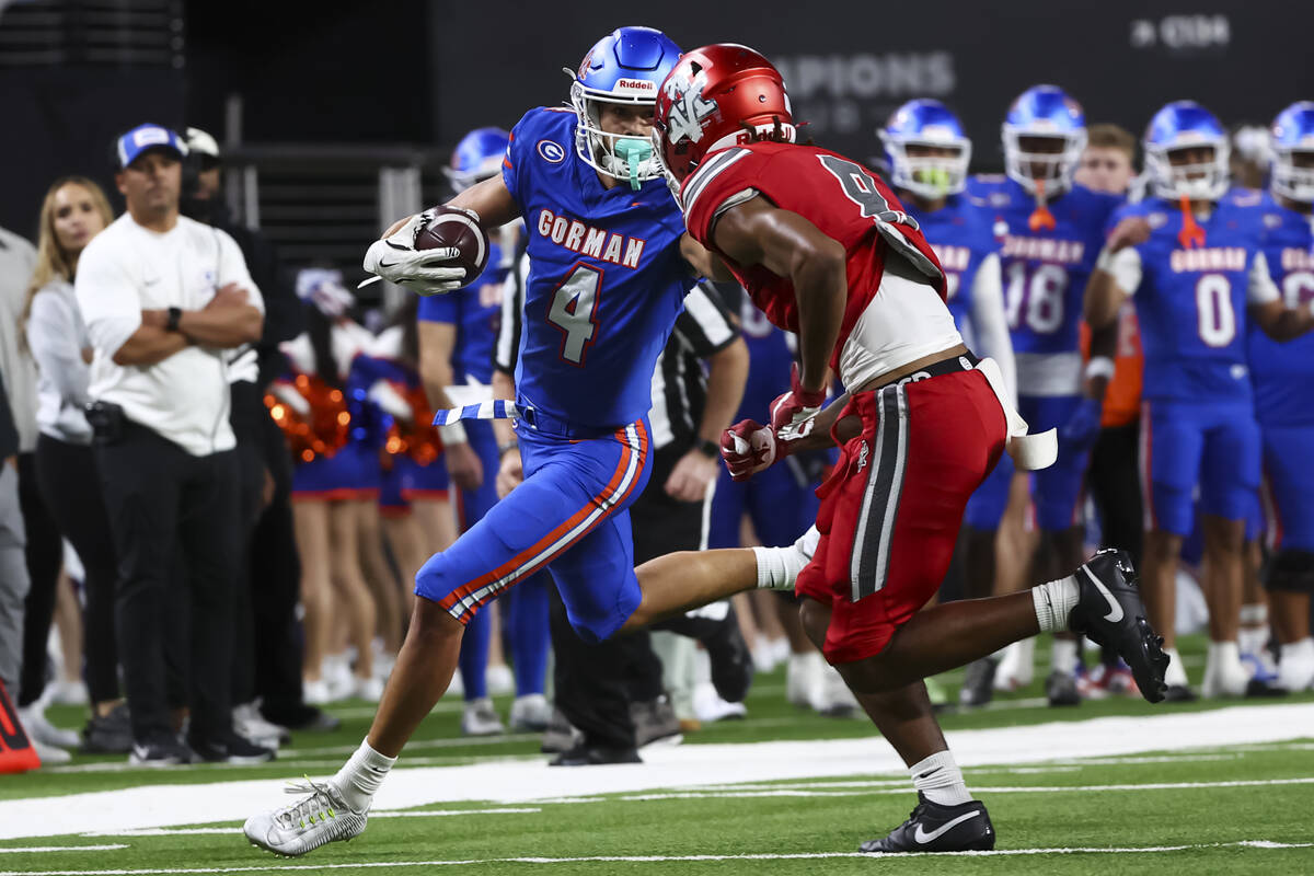 Bishop Gorman wide receiver Kaina Watson (4) runs the ball as Arbor View’s JT Cole (8) d ...