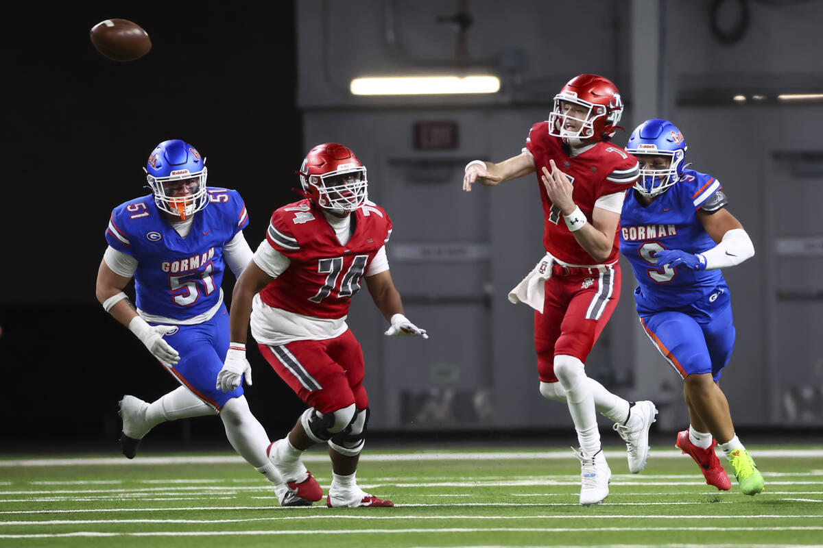 Arbor View quarterback Thaddeus Thatcher (7) throws a pass under pressure from Bishop Gorman&#x ...