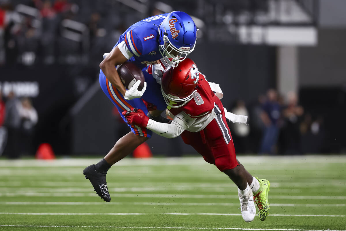 Bishop Gorman defensive back Isaiah Nickels (1) gets tackled by Arbor View’s Kamareion B ...