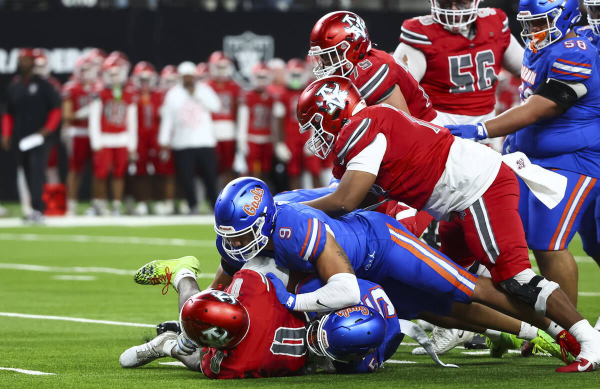 Arbor View’s Kamareion Bell (0) gets tackled by Bishop Gorman’s Andreas Nicolaidi ...