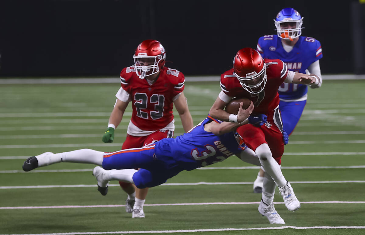 Bishop Gorman linebacker Anton Gorup (33) tackles Arbor View quarterback Thaddeus Thatcher (7) ...