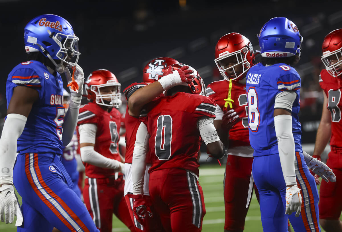Arbor View Kamareion Bell (0) celebrates his touchdown with teammates during the second half of ...