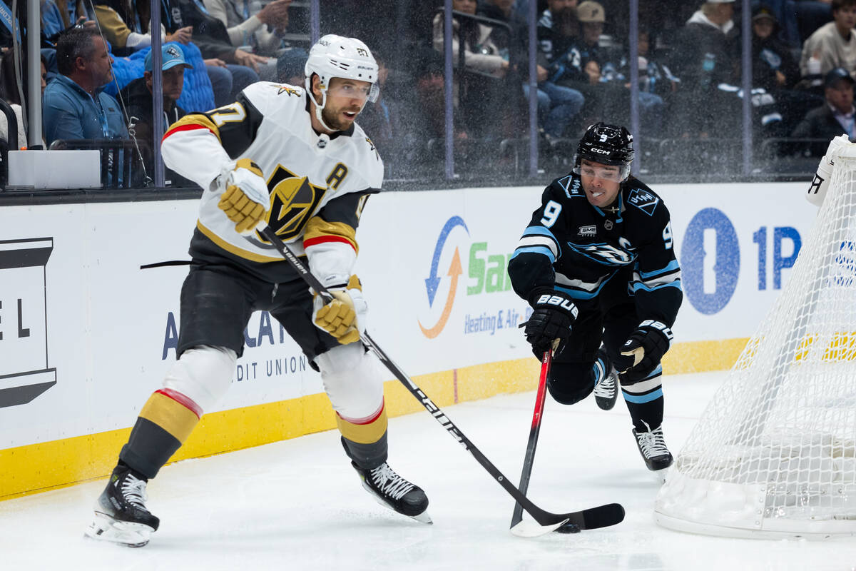 Utah Mammoth right wing Clayton Keller (9) tries to take the puck from Vegas Golden Knights def ...
