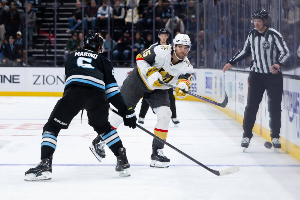 Vegas Golden Knights defenseman Noah Hanifin (15) passes the puck past Utah Mammoth defenseman ...