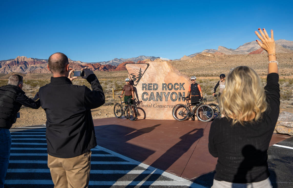 Cyclist are some of the first visitors to snap a photo in front of the relocated Red Rock Canyo ...
