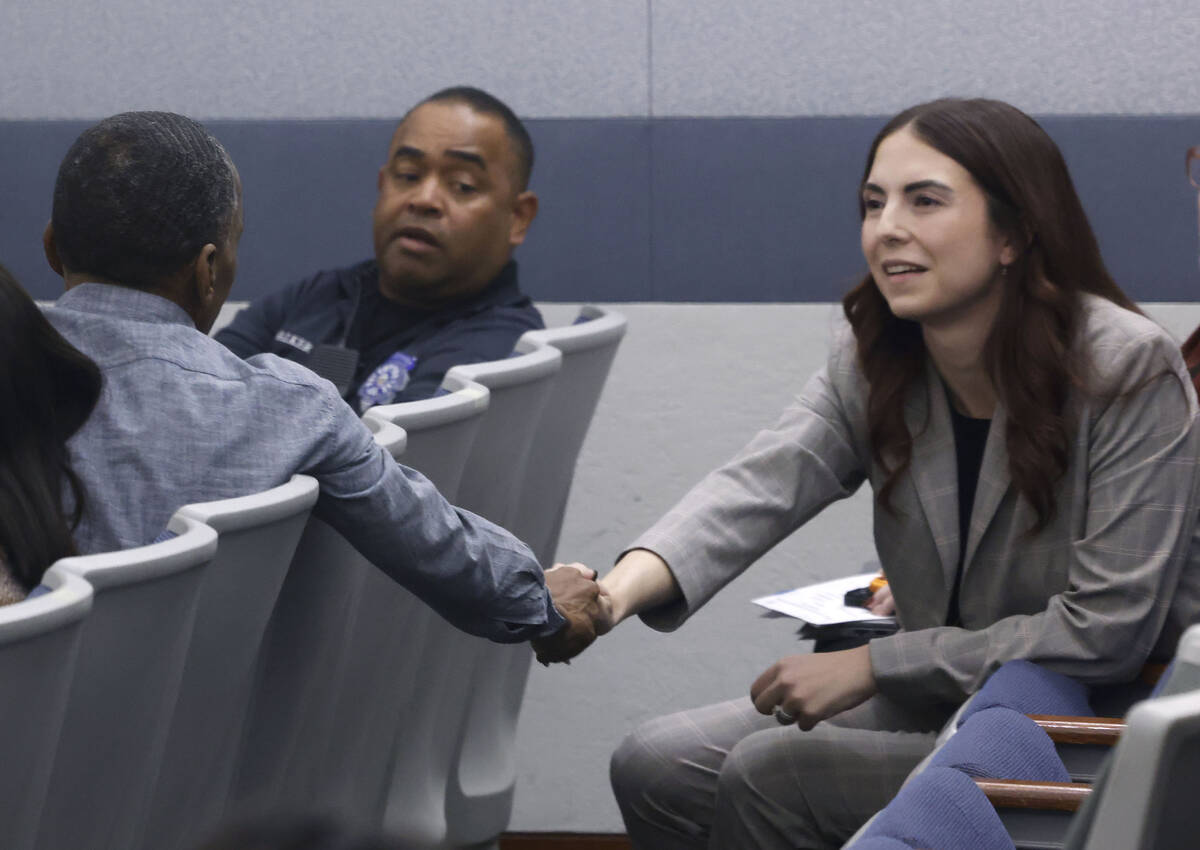 Morgan Lombardo, right, shakes hands with a family member of Stanley Weaver, who pleaded guilty ...