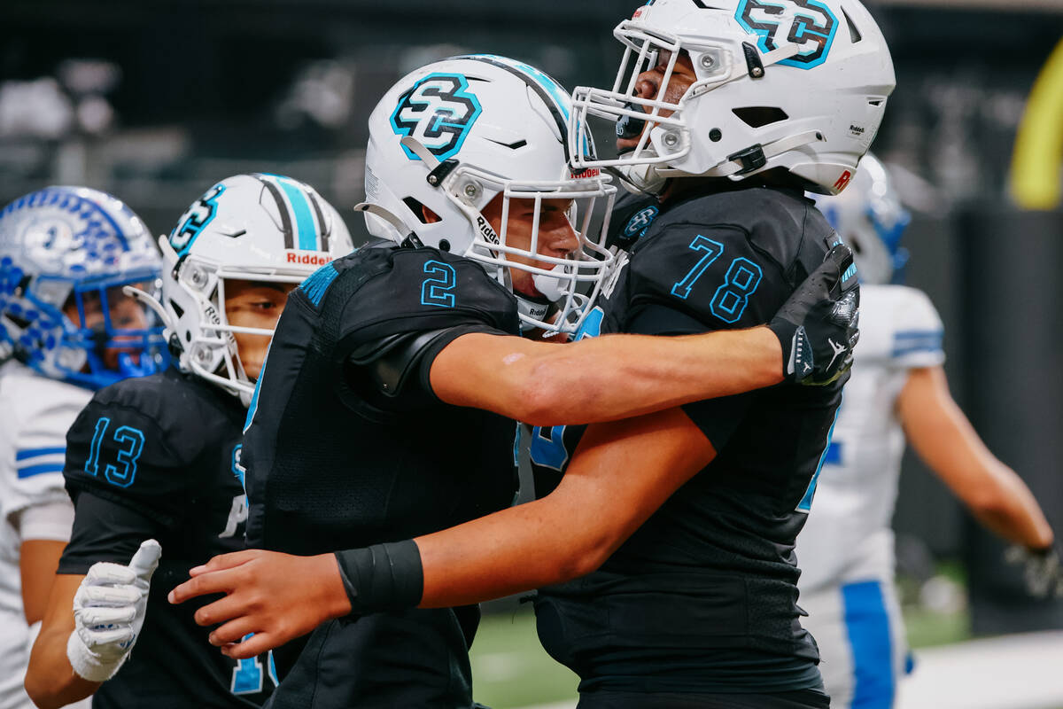Sloan Canyon wide receiver Brandon Quaglio (2) and offensive lineman Jonah Polu (78) celebrate ...