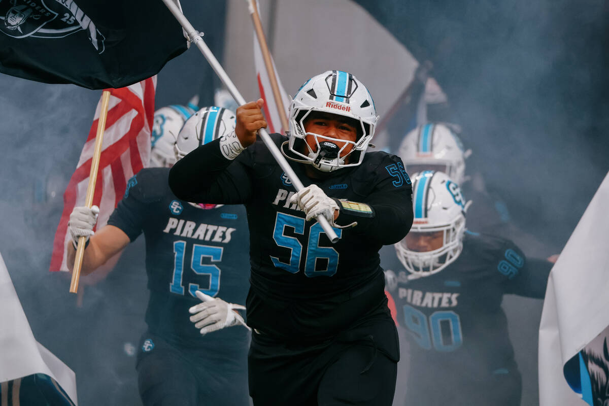 Sloan Canyon offensive lineman Vili Tupou (56) runs out before the 4A State Championship game o ...