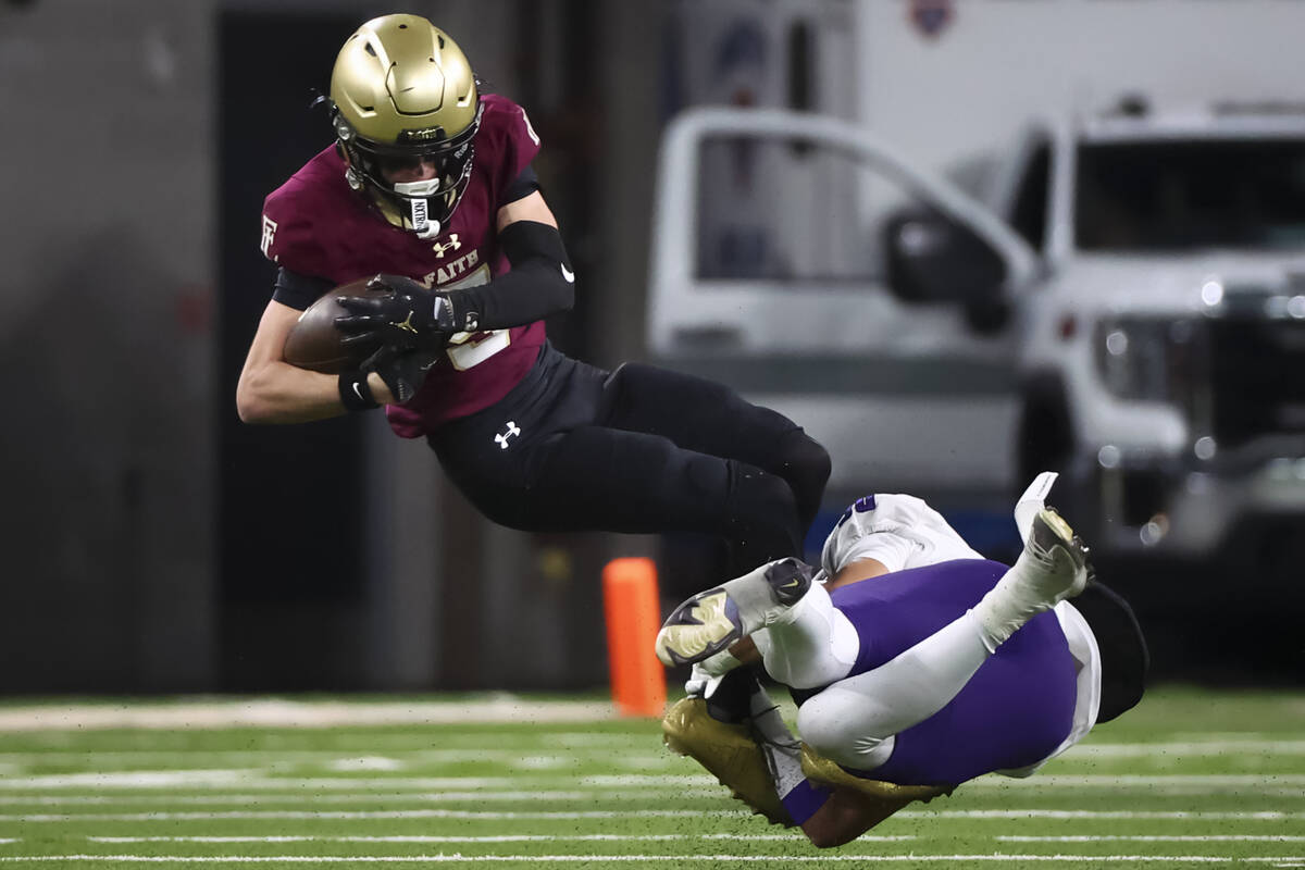 Faith Lutheran wide receiver Jaden Mason (5) gets tackled by Spanish Springs’ Marian Mar ...
