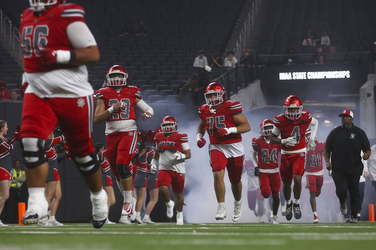 Arbor View players run onto the field before taking on Bishop Gorman in the Open Division NIAA ...