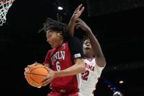 UNLV forward Tyrin Jones (6) grabs a rebound in front of Alabama forward Aiden Sherrell (22) du ...