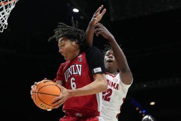 UNLV forward Tyrin Jones (6) grabs a rebound in front of Alabama forward Aiden Sherrell (22) du ...