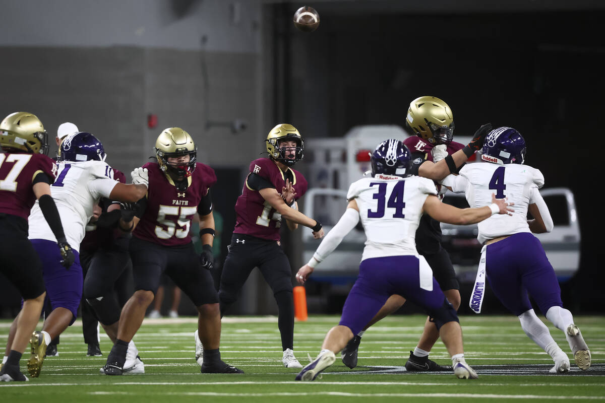 Faith Lutheran quarterback Dominick Folino (14) throws a pass during first half of the Class 5A ...
