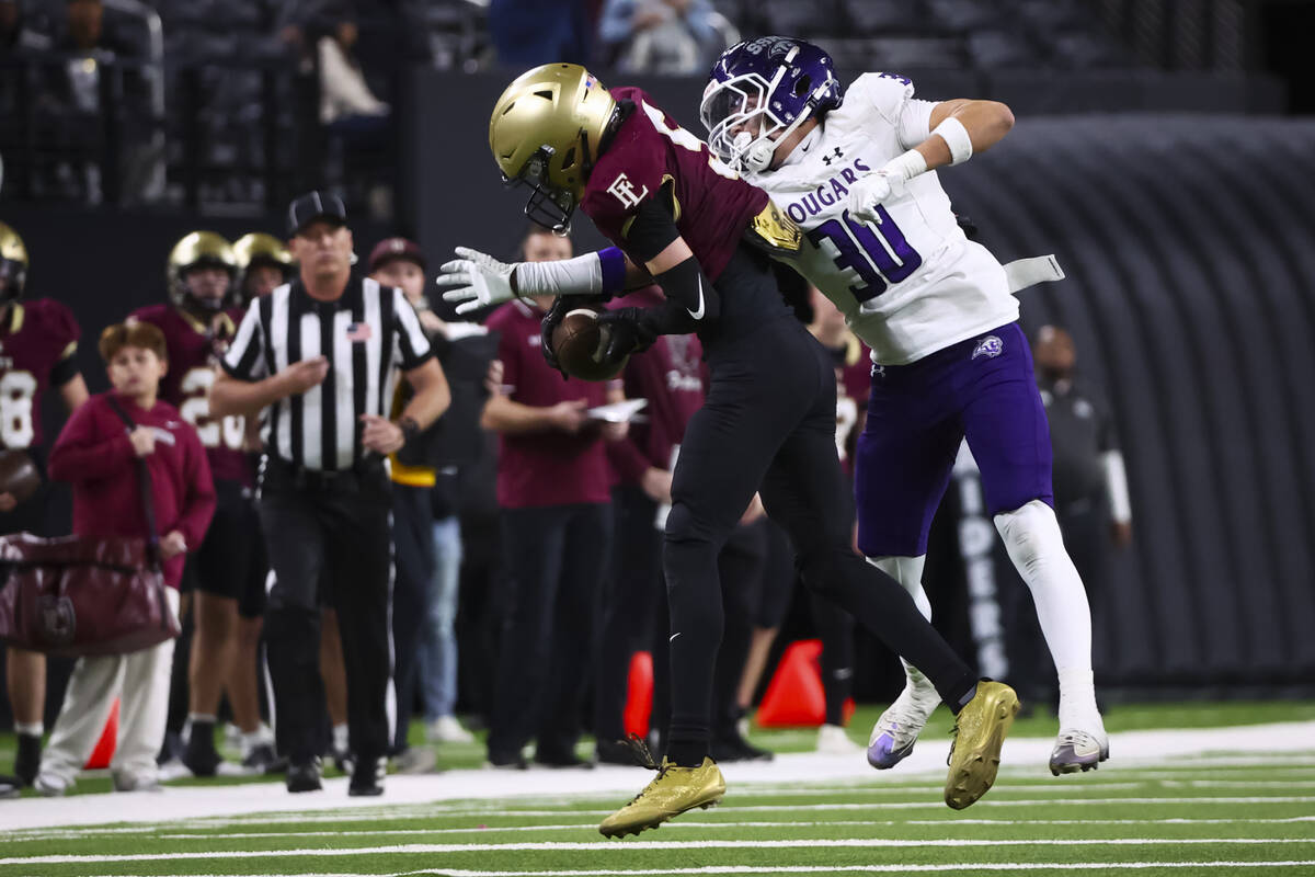 Faith Lutheran wide receiver Jaden Mason (5) holds onto a reception under pressure from Spanish ...