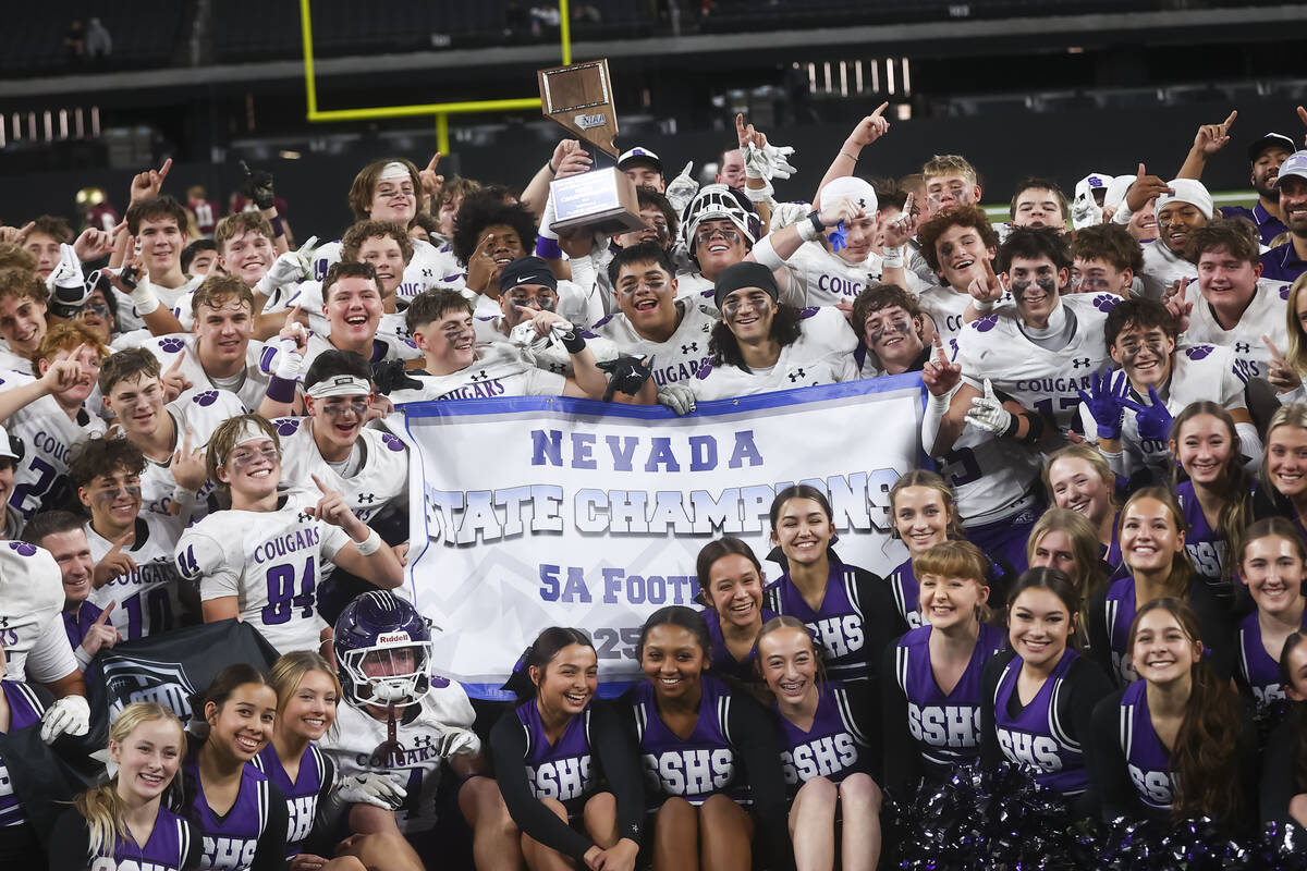 Spanish Springs players pose with the trophy after defeating Faith Lutheran to win the Class 5A ...
