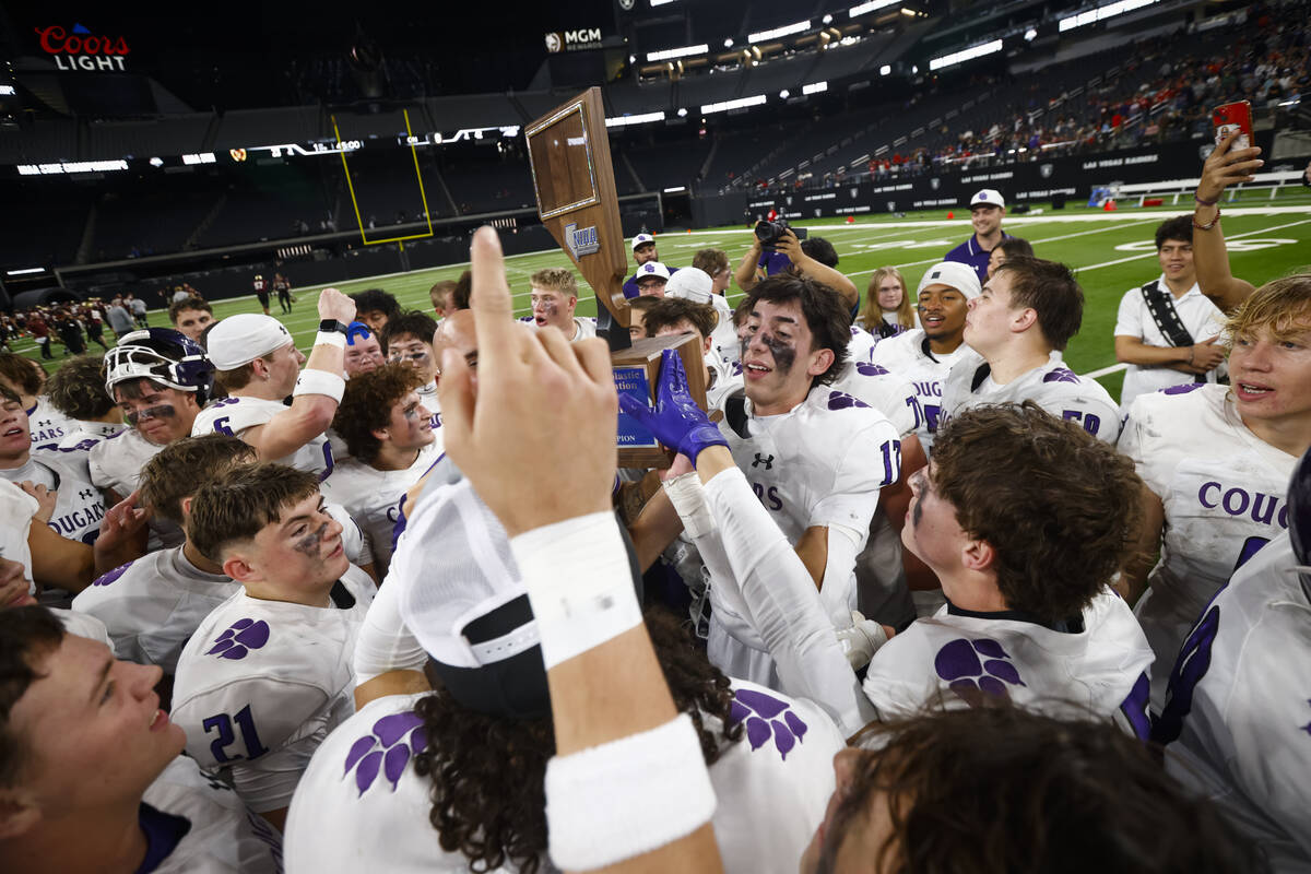 Spanish Springs players celebrate with the trophy after defeating Faith Lutheran to win the Cla ...