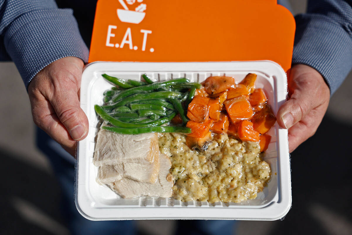 An example of a pre-cooked holiday meal from E.A.T. being given away outside Vegas Stronger Wed ...