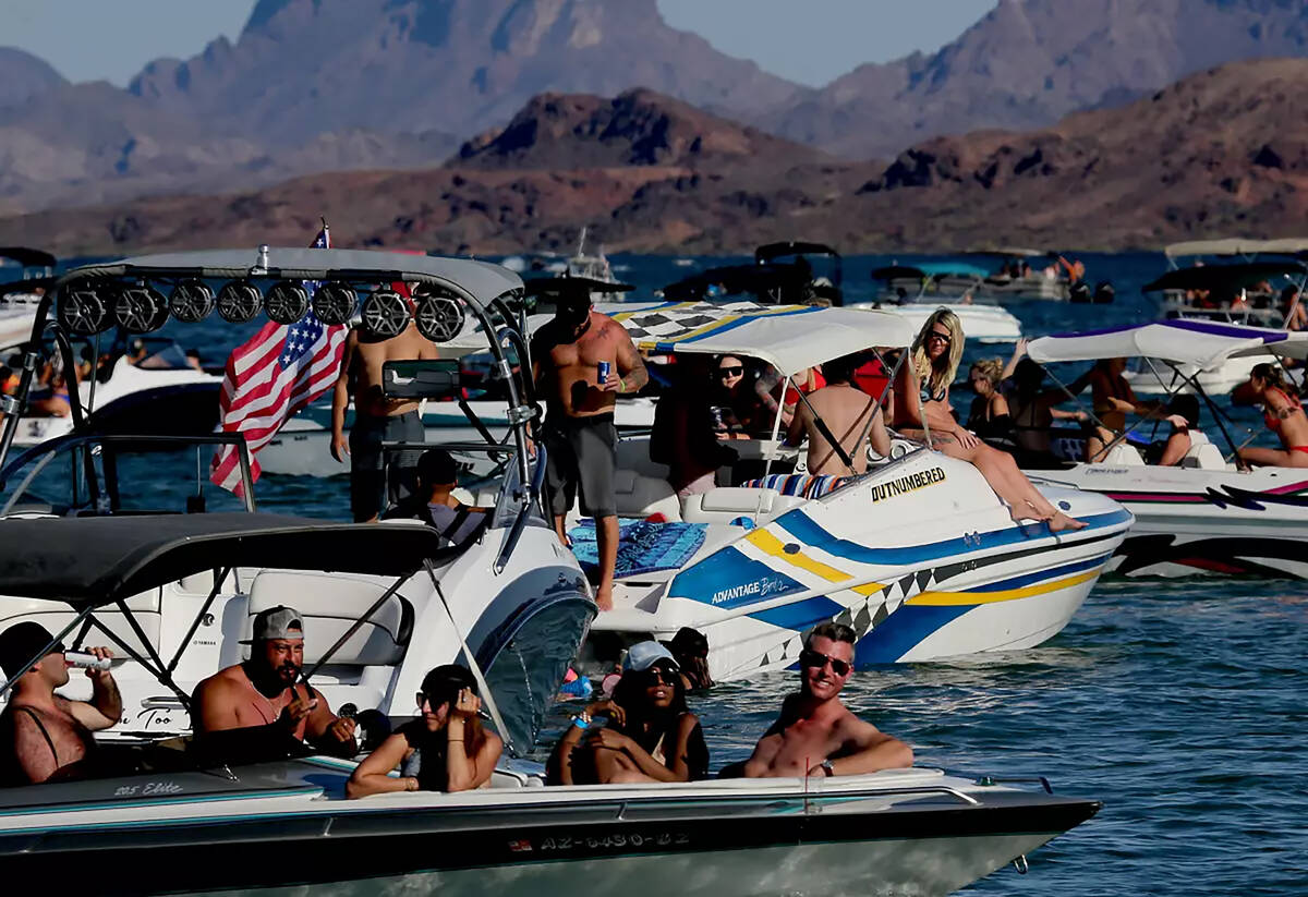 Packed boats bob in Lake Havasu, a reservoir of Colorado River water created by the Parker Dam ...