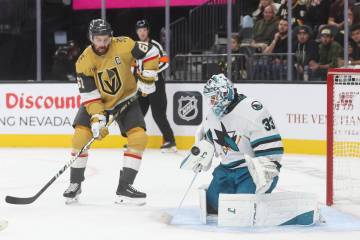San Jose Sharks goaltender Alex Nedeljkovic (33) stops the puck as Golden Knights right wing Ma ...