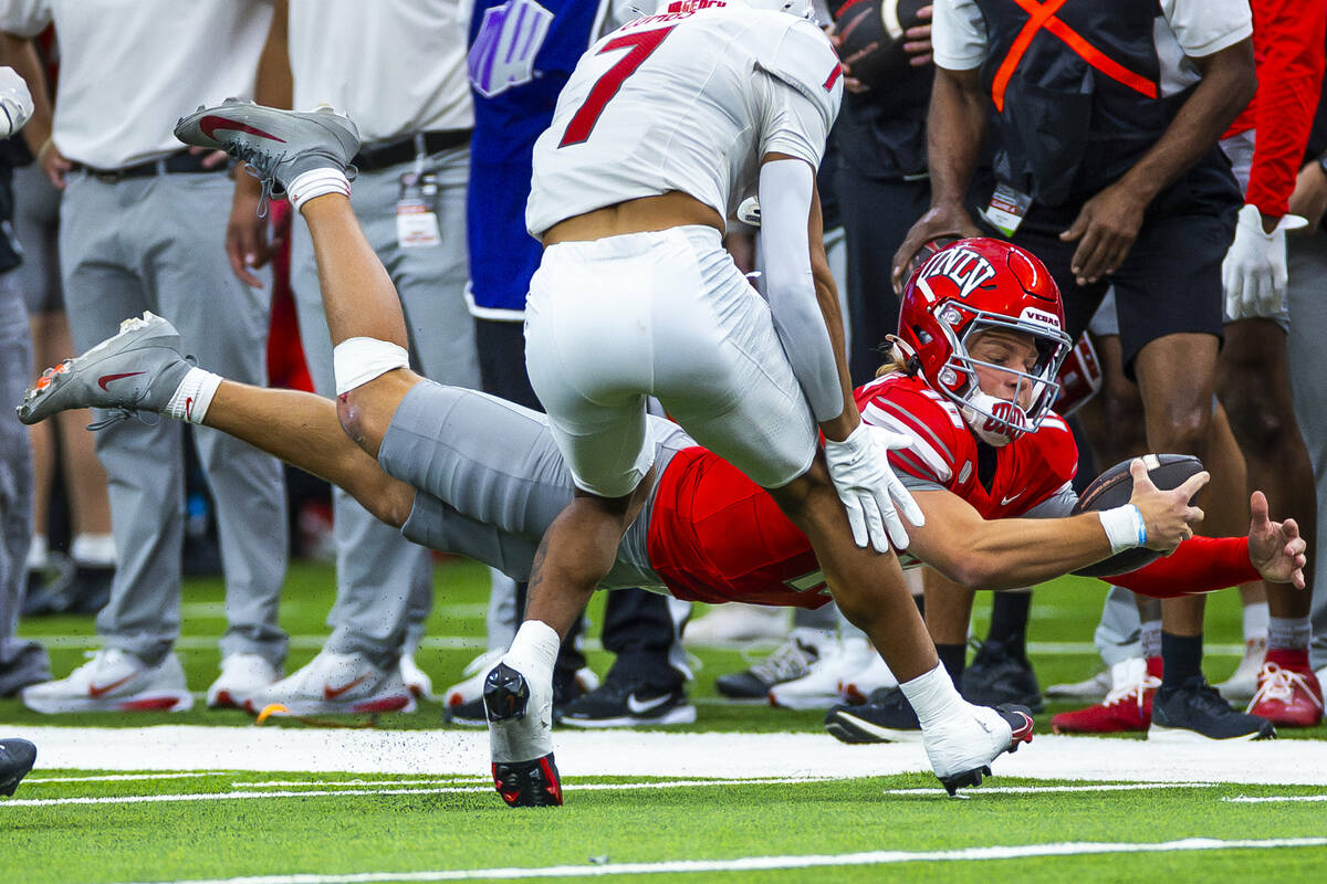 UNLV quarterback Anthony Colandrea (10) dives for a late first down as New Mexico Lobos safety ...