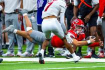 UNLV quarterback Anthony Colandrea (10) dives for a late first down as New Mexico Lobos safety ...