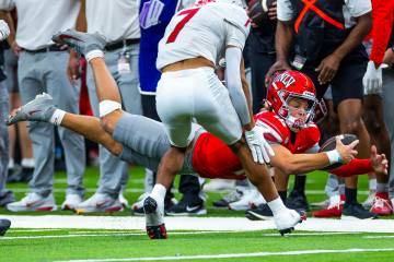 UNLV quarterback Anthony Colandrea (10) dives for a late first down as New Mexico Lobos safety ...