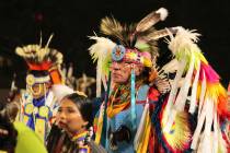 Native American and Indigenous dancers pack an arena during a grand entry procession at the ann ...