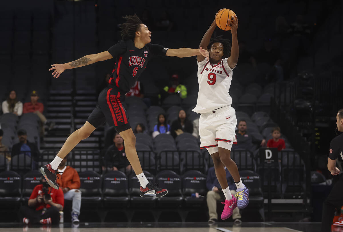 UNLV forward Tyrin Jones (6) tries to intercept a pass to Rutgers forward Dylan Grant (9) durin ...