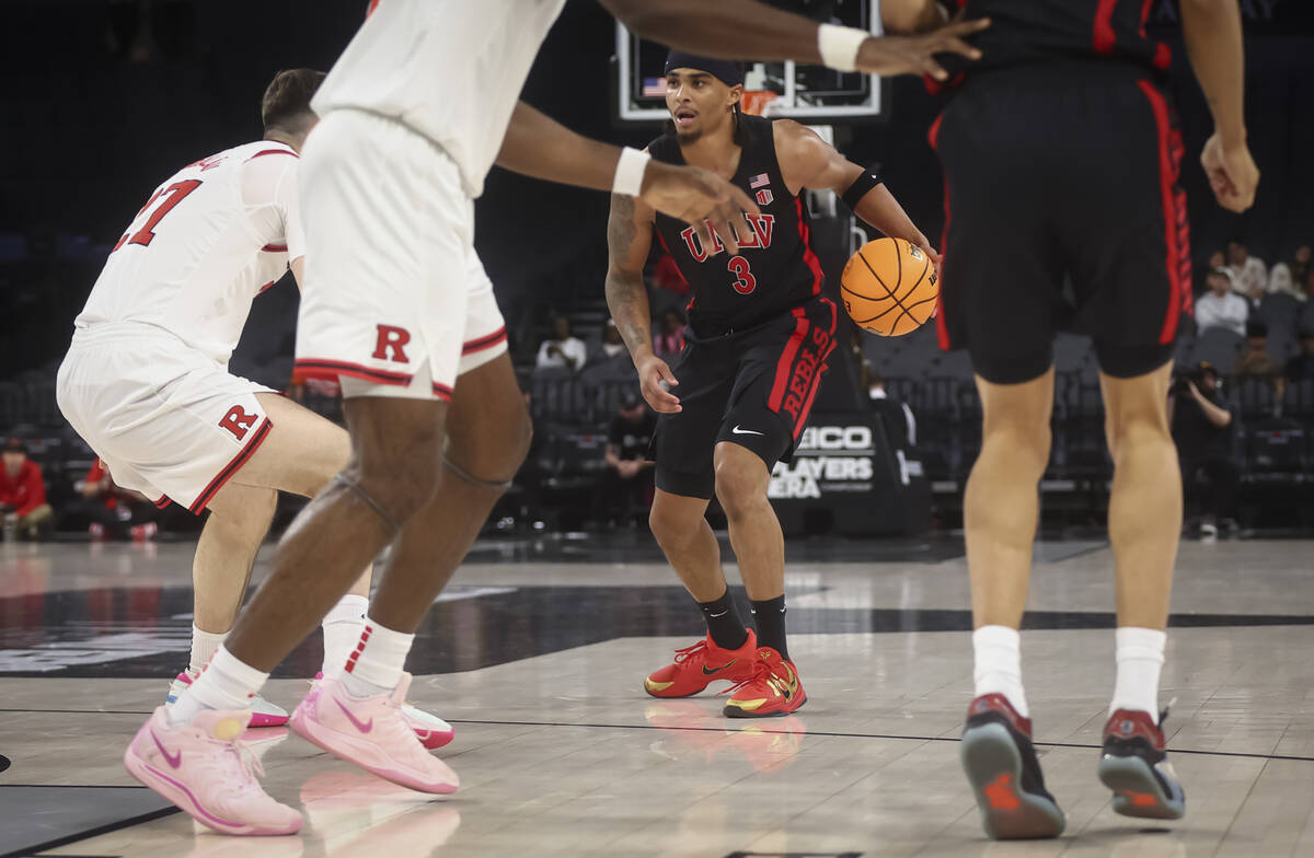 UNLV guard Howie Fleming Jr. (3) brings the ball up court against Rutgers during the first half ...