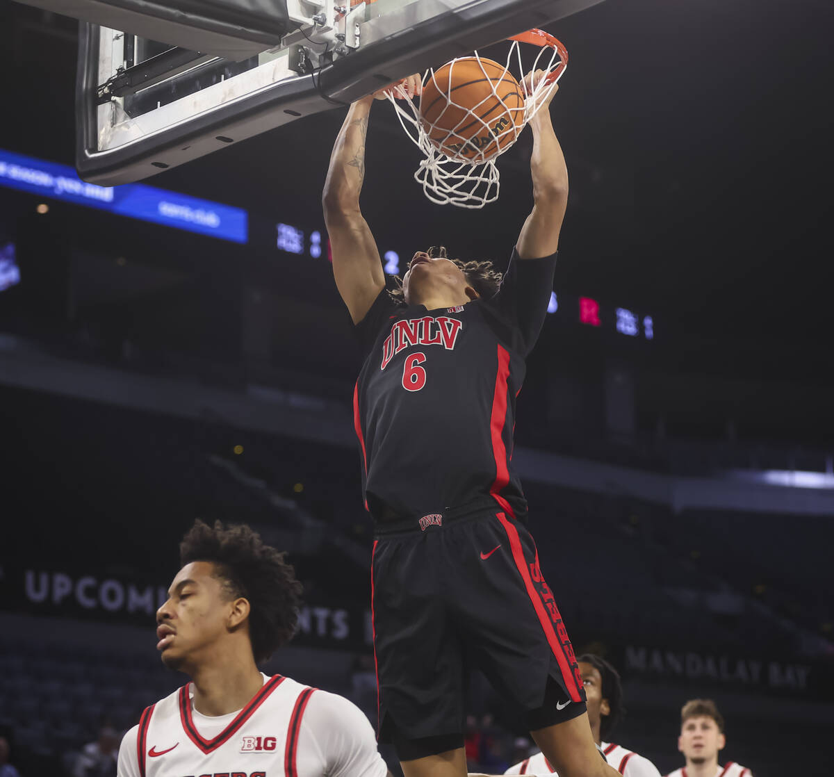 UNLV forward Tyrin Jones (6) dunks the ball against Rutgers during the first half of a game in ...