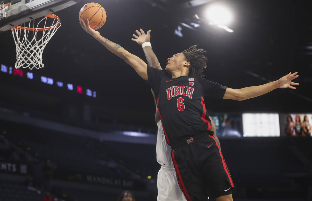 UNLV forward Tyrin Jones (6) lays up the ball against Rutgers center Emmanuel Ogbole, obscured, ...