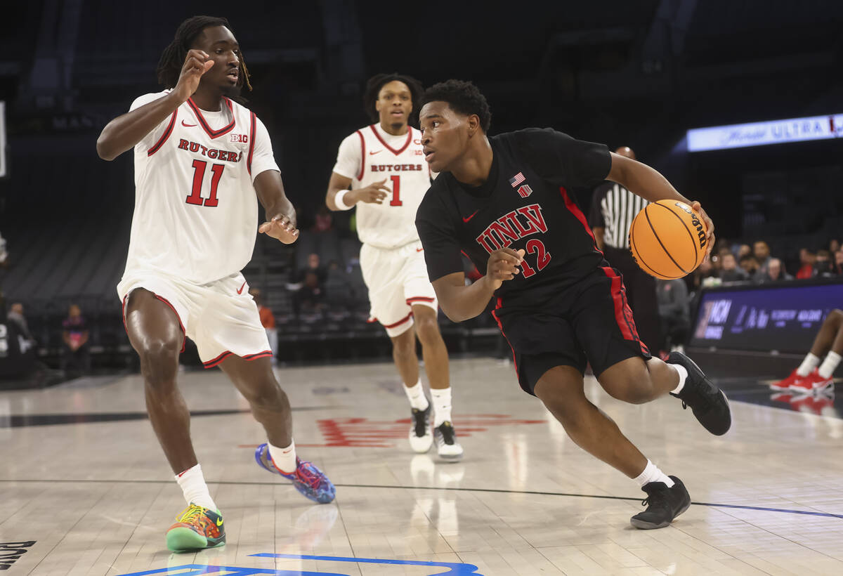 UNLV guard Issac Williamson (12) drives to the basket against Rutgers forward Christopher Nwuli ...