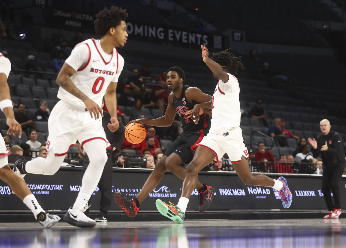UNLV forward Kimani Hamilton (2) drives the ball as Rutgers guard Jamichael Davis (1) defends d ...