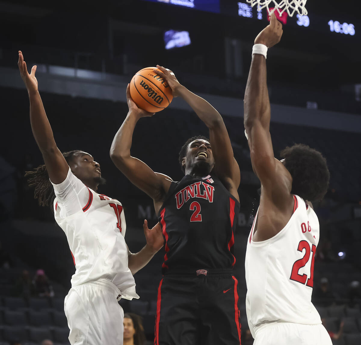 UNLV forward Kimani Hamilton (2) tries to shoot between Rutgers forward Christopher Nwuli (11) ...