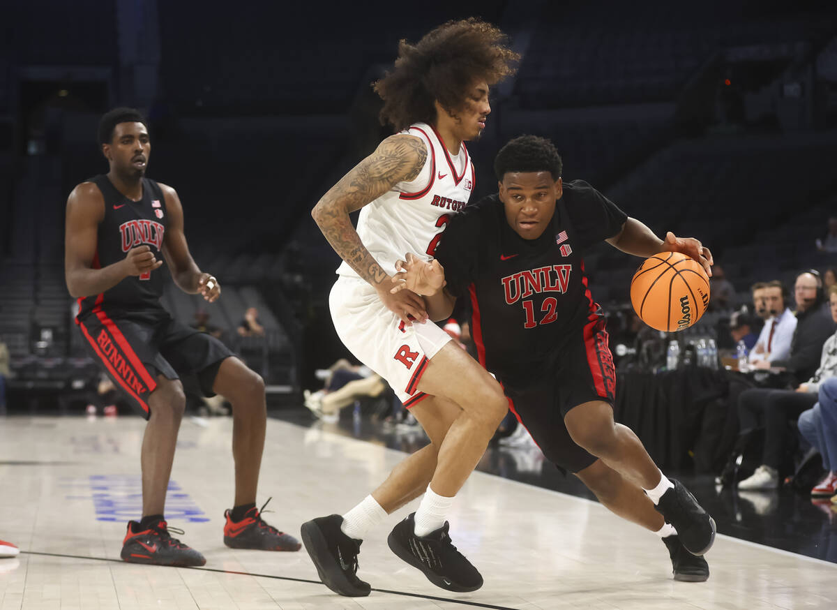 UNLV guard Issac Williamson (12) drives to the basket against Rutgers guard Lino Mark (2) durin ...