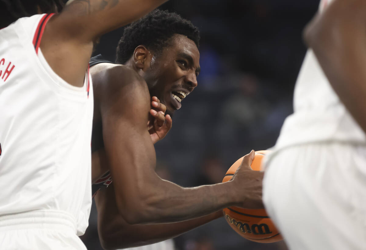 UNLV forward Kimani Hamilton (2) tries to get an open shot under pressure from Rutgers forward ...
