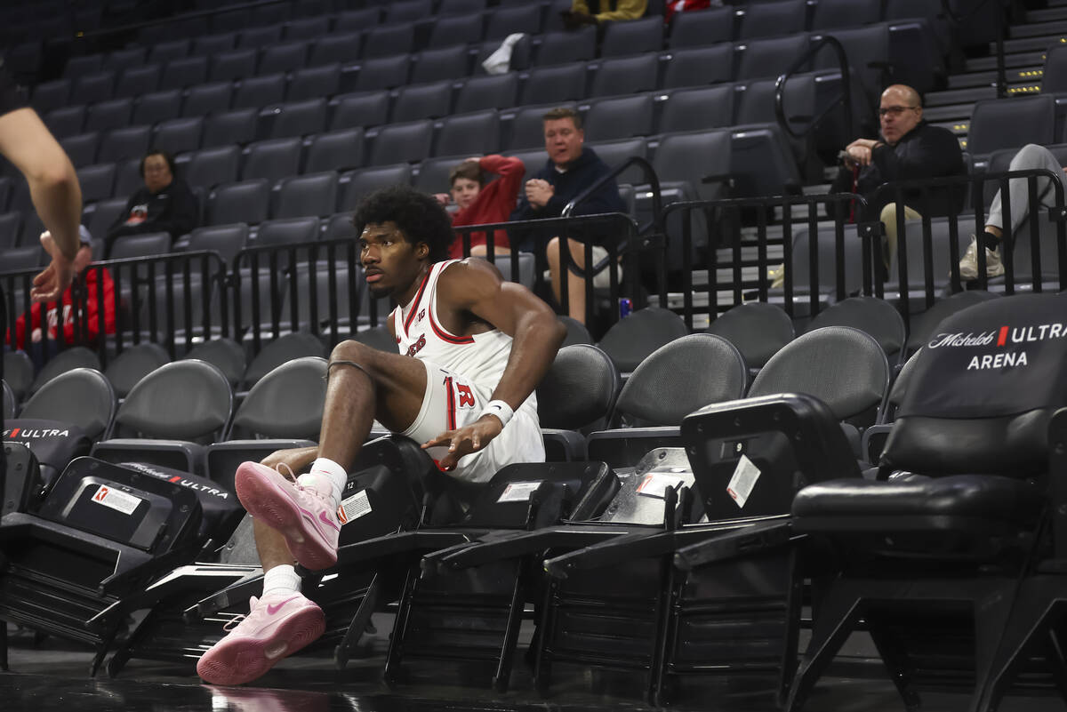 Rutgers center Emmanuel Ogbole (21) falls into chairs during the second half of a game against ...