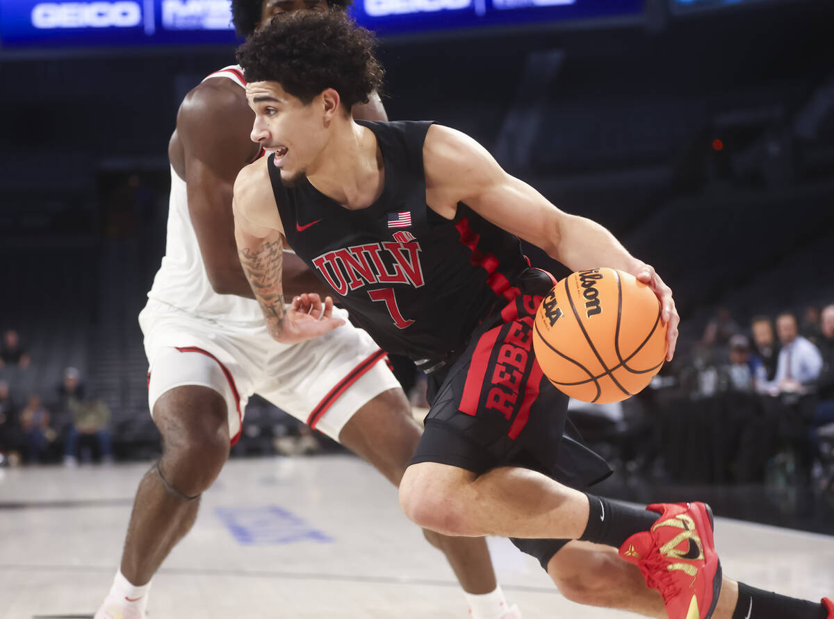 UNLV guard Al Green (7) drives to the basket against Rutgers center Emmanuel Ogbole (21) during ...