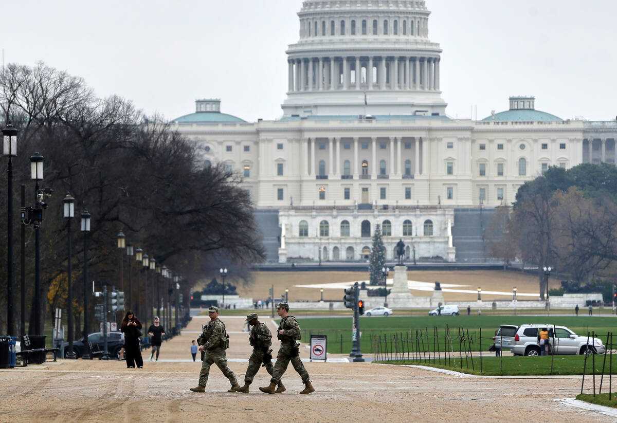National Guard patrol on the National Mall near the U.S. Capitol, Wednesday, Nov. 26, 2025, in ...