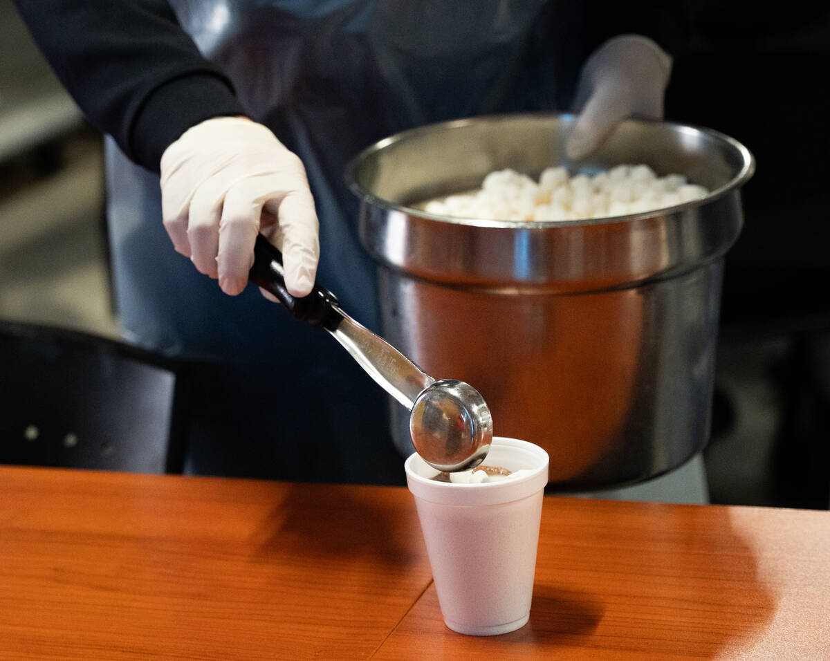 Hot chocolate is served with marshmallows during Catholic Charities of Southern Nevada’s ...