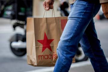 A shopper carries a Macy's bag through Union Square as retailers prepare for Black Friday in Sa ...