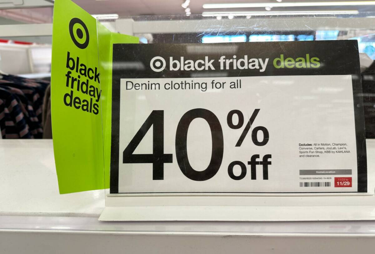 Signs denote Black Friday deals already available on clothing in a Target store, Wednesday, Nov ...