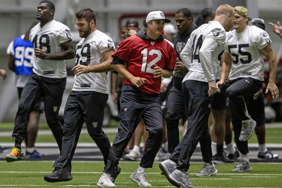 Raiders quarterback Aidan O'Connell (12) jogs during the team’s practice at the Int ...
