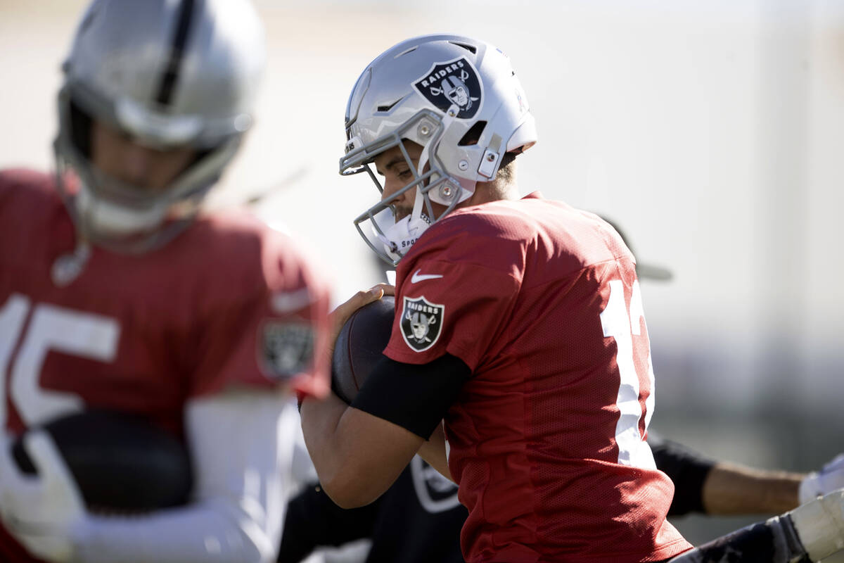 Raiders quarterback Aidan O'Connell (12) runs through a drill during the team’s pra ...