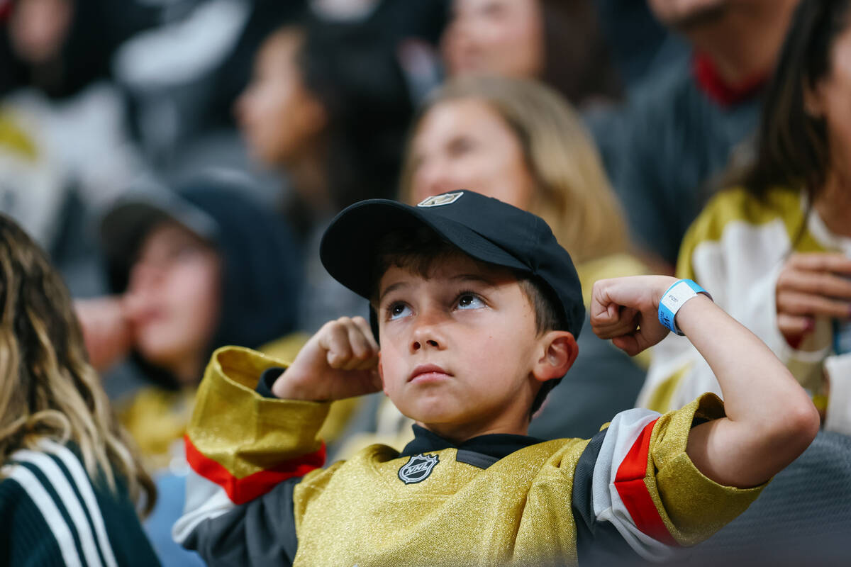 A Golden Knights fan flexes for a chance to be on the Jumbotron during the first period of the ...